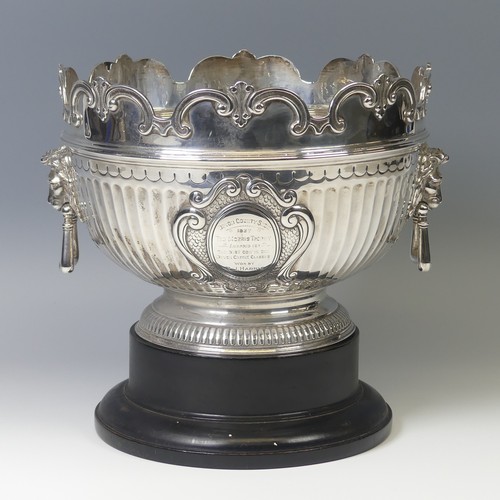 A Victorian silver Punch Bowl, by Walter & John Barnard, hallmarked London 1894, Monteith style rim with fluted decoration, gadrooned circular foot, with two lion mask ring handles, the cartouche with presentation inscription from 'Devon County Show....The Best Cow in the Cattle Classes....' dated 1937, 24cm diameter, 35.3ozt, on ebonised wooden stand.