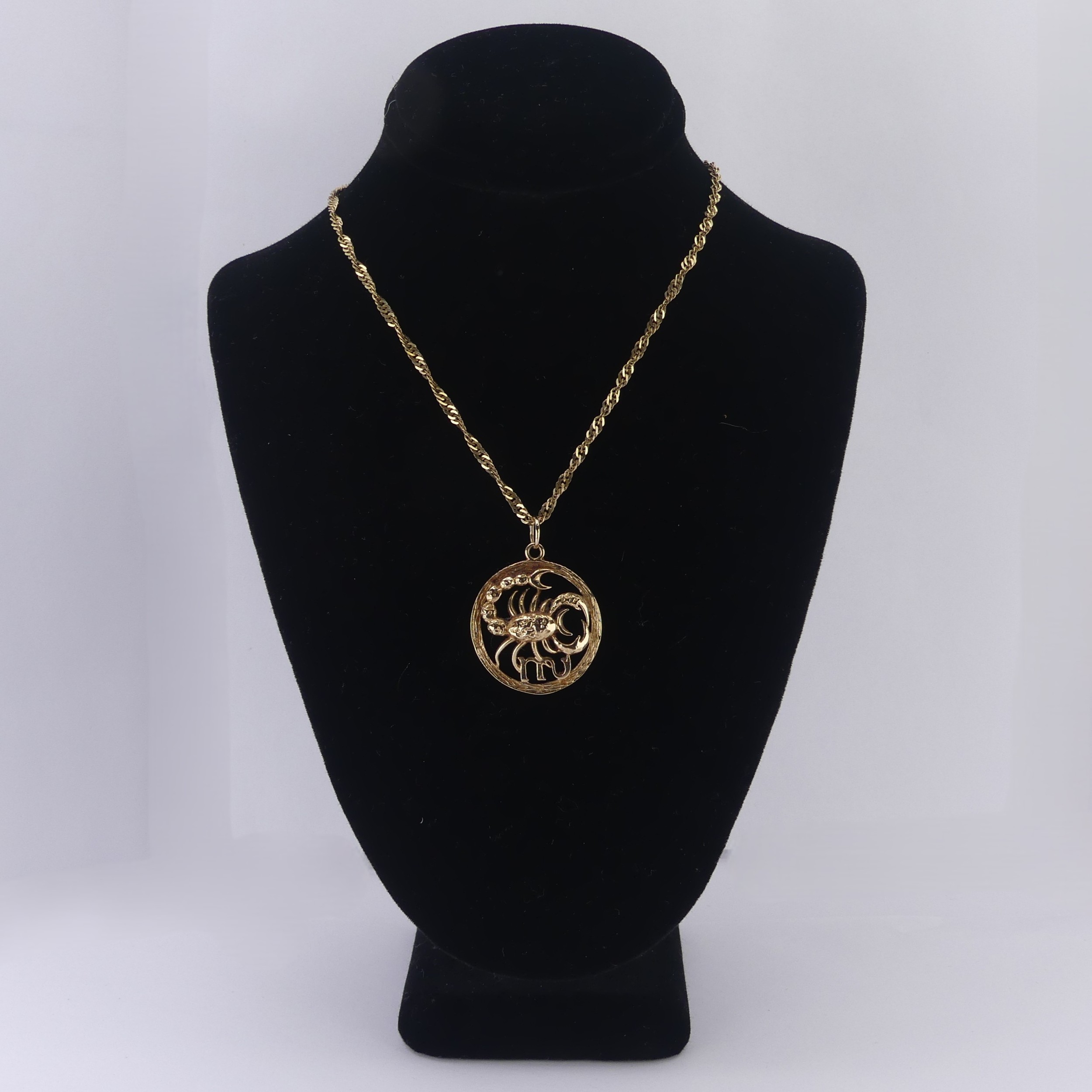 A 9ct yellow gold Zodiac 'Cancer' Pendant, 24mm diameter, on a 9ct gold ...