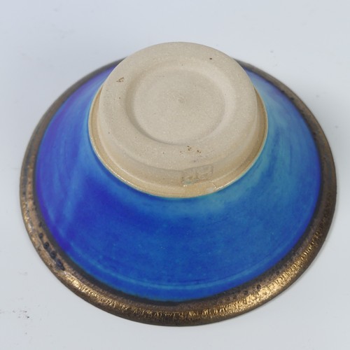 58 - A art glass green bowl/ashtray, possibly Whitefriars, 9cm high, D 13cm, together with a pale blue gl... 