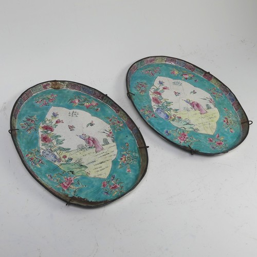 16 - A pair of Chinese Canton enamel-on-copper famille rose oval Dishes, 19th century, iron red four char... 