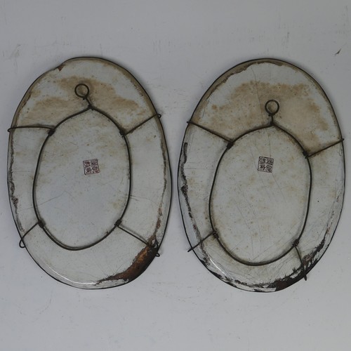 16 - A pair of Chinese Canton enamel-on-copper famille rose oval Dishes, 19th century, iron red four char... 