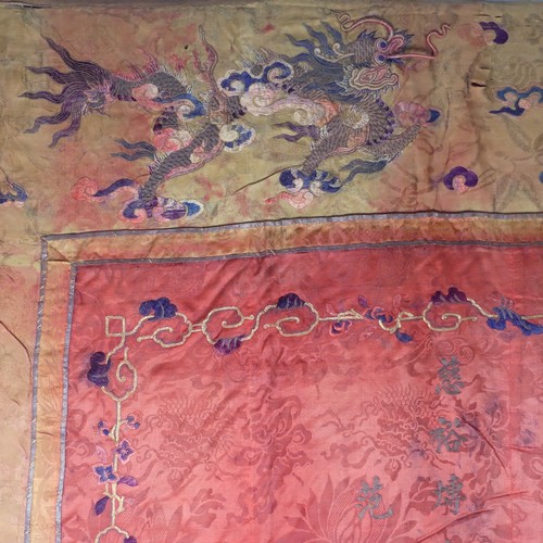 15 - Chinese textiles: a Qing Dynasty embroidered silk brocade wall hanging, the central panel in red bro... 