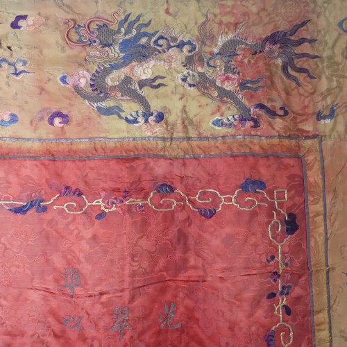 15 - Chinese textiles: a Qing Dynasty embroidered silk brocade wall hanging, the central panel in red bro... 