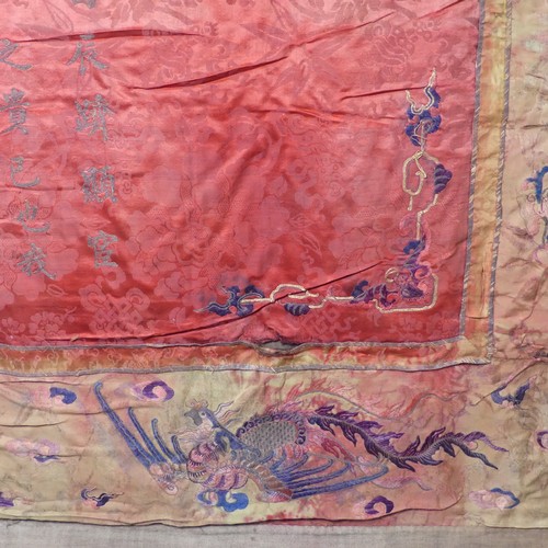 15 - Chinese textiles: a Qing Dynasty embroidered silk brocade wall hanging, the central panel in red bro... 