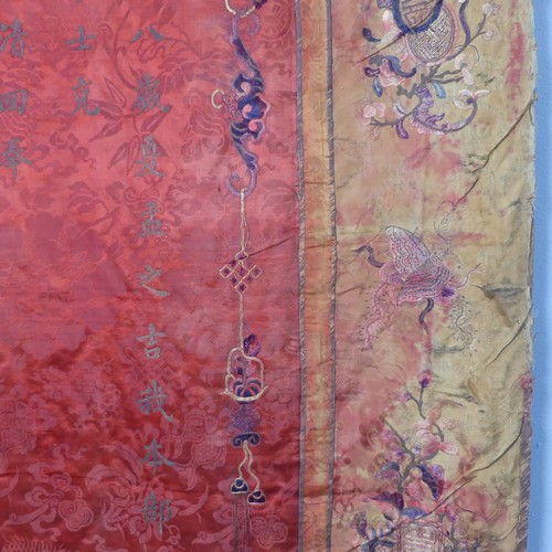 15 - Chinese textiles: a Qing Dynasty embroidered silk brocade wall hanging, the central panel in red bro... 