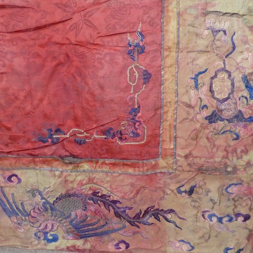 15 - Chinese textiles: a Qing Dynasty embroidered silk brocade wall hanging, the central panel in red bro... 