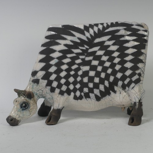 93A - Lawson E. Rudge (b. 1936),&nbsp;a raku fired, studio pottery sculpture of a Grazing Cow, with crackl... 