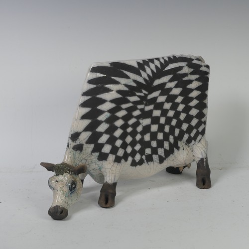 93A - Lawson E. Rudge (b. 1936),&nbsp;a raku fired, studio pottery sculpture of a Grazing Cow, with crackl... 