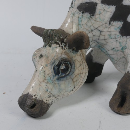 93A - Lawson E. Rudge (b. 1936),&nbsp;a raku fired, studio pottery sculpture of a Grazing Cow, with crackl... 