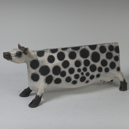 93B - Lawson E. Rudge (b. 1936), a raku fired, studio pottery sculpture of a Cow, with crackle glaze, numb... 