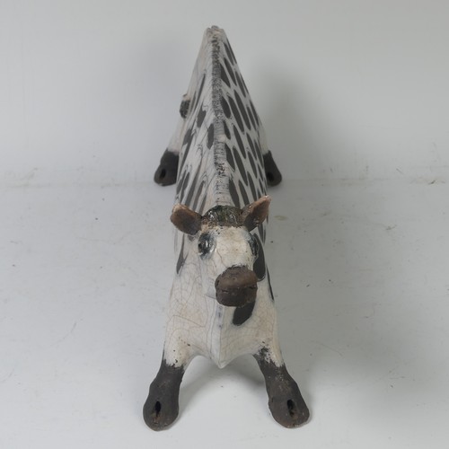93B - Lawson E. Rudge (b. 1936), a raku fired, studio pottery sculpture of a Cow, with crackle glaze, numb... 