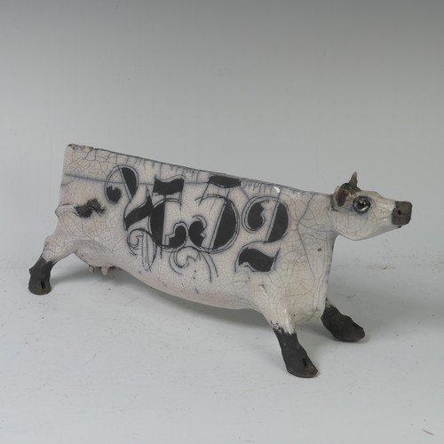93B - Lawson E. Rudge (b. 1936), a raku fired, studio pottery sculpture of a Cow, with crackle glaze, numb... 