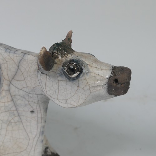 93B - Lawson E. Rudge (b. 1936), a raku fired, studio pottery sculpture of a Cow, with crackle glaze, numb... 