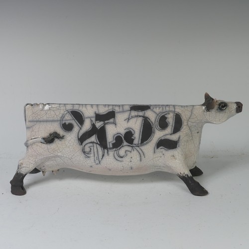 93B - Lawson E. Rudge (b. 1936), a raku fired, studio pottery sculpture of a Cow, with crackle glaze, numb... 