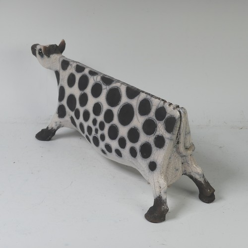 93B - Lawson E. Rudge (b. 1936), a raku fired, studio pottery sculpture of a Cow, with crackle glaze, numb... 