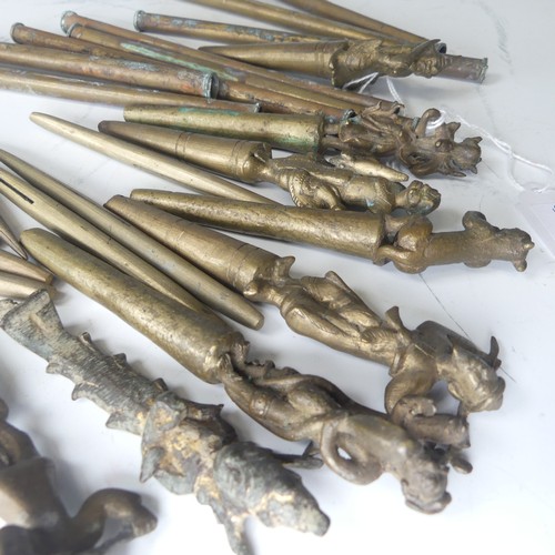 49 - A collection of eight bronze Burmese tattoo carved counterweights and needles, circa 19th century, i... 