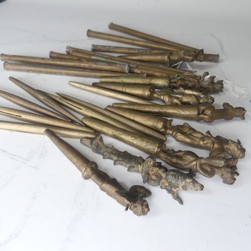 49 - A collection of eight bronze Burmese tattoo carved counterweights and needles, circa 19th century, i... 