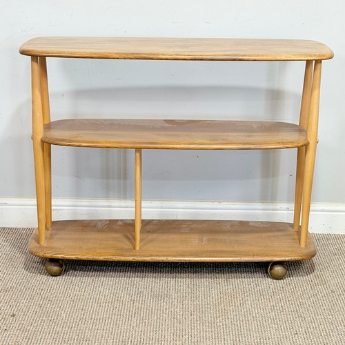 10 - Lucian Ercolani for Ercol; a No.361 beech and elm 'Baby Giraffe' open Bookcase, raised on castors, W... 