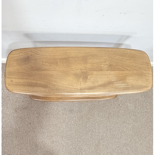 10 - Lucian Ercolani for Ercol; a No.361 beech and elm 'Baby Giraffe' open Bookcase, raised on castors, W... 