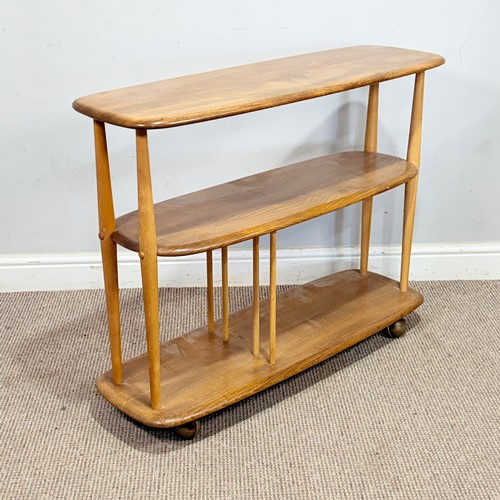 10 - Lucian Ercolani for Ercol; a No.361 beech and elm 'Baby Giraffe' open Bookcase, raised on castors, W... 