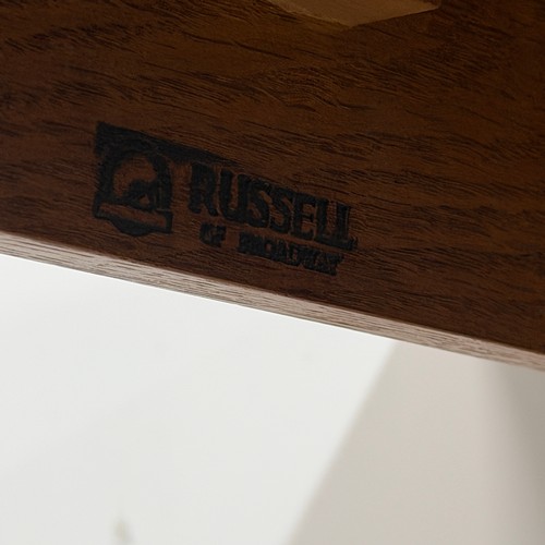 14 - A Gordon Russell oak extending dining Table, retailed by Heals of London, raised on tapering support... 