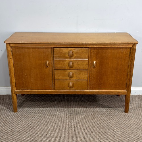 13 - A mid-20th century Cotswold School light oak Sideboard, by Heals of London, the central drop of four... 