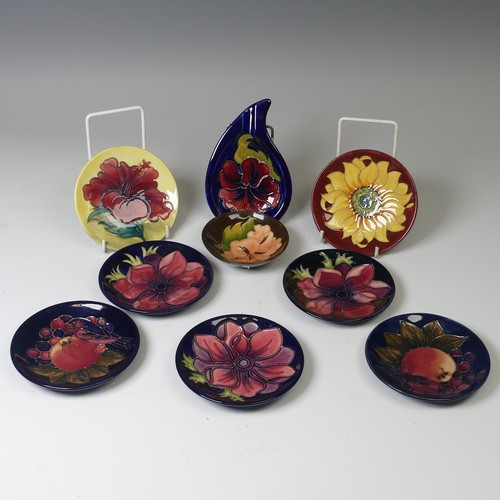 A Collection of seven Moorcroft Pottery pin Dishes, of various patterns, including; three ‘Anemone’, dated 1994, 1995 and 1995, two ‘Finch and Pomegranate’, dated 1995, ‘Inca’, dated 1995, and ‘Hibiscus’, all with impressed marks to base, 12cm diameter, together with a further Moorcroft 'Hibiscus' Ash Tray, impressed mark to base, 15cm wide, ‘Hibiscus’ pattern dish, impressed mark to base, 9.5cm diameter. (9)