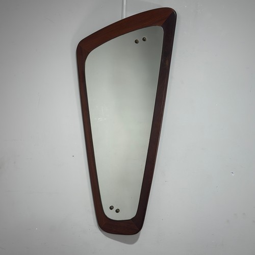 21 - A Danish mid-20th century asymmetrical teak wall Mirror, W 35 cm x H 76 cm.