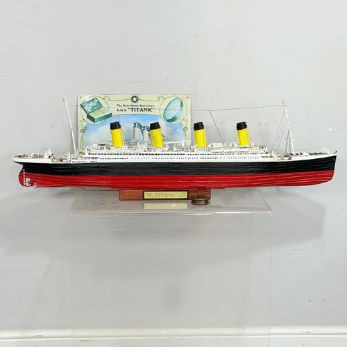 51 - A scratch built wooden and painted Model of the RMS Titanic, displayed on a wooden plinth, L 105 cm,... 