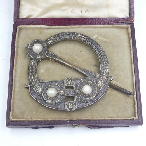444 - A mid-19thC Irish Tara Brooch, of traditional form set three half pearls, the reverse marked for 'We... 