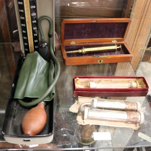 332 - BRASS SYRINGE IN DISPLAY CASE, BOXED EAR SYRINGE, VINTAGE BLOOD PRESSURE MONITOR AND ONE OTHER