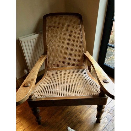 287 - SOUTH ASIAN TEAK AND RATTAN PLANTERS CHAIR WITH EXTENDING ARMS