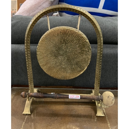 354 - A BRASS DINNER GONG WITH INLAID CROSS MOTIF