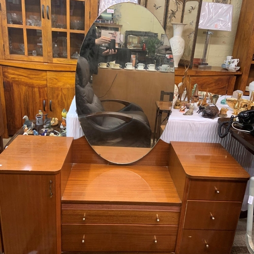 417 - VINTAGE TEAK AUSTIN SUITE DRESSING TABLE OF 5 DRAWERS AND ONE CUPBOARD WITH OVAL FRAMED MIRROR