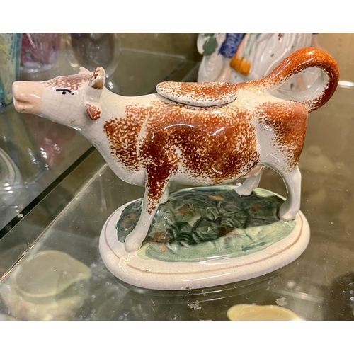 249 - A VICTORIAN CERAMIC CREAMER IN THE SHAPE OF A COW WITH ORIGINAL LID