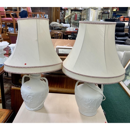 283 - PAIR TWO HANDLED WHITE TABLE LAMPS DEPICTING GREEK MYTHOLOGY, BOTH WITH SHADES