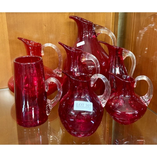 307 - X6 VARIOUS CRANBERRY GLASS JUGS WITH A CRANBERRY GLASS TANKARD