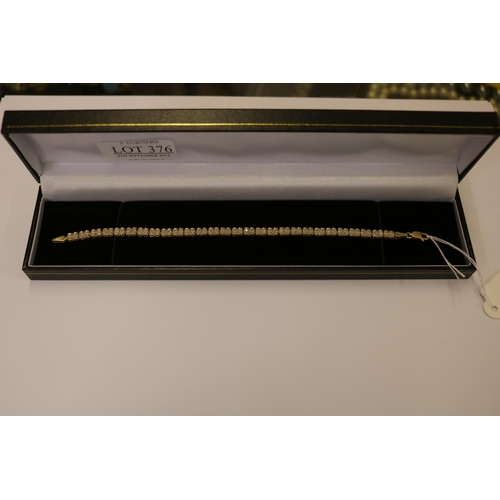 376 - 9CT GOLD AND DIAMOND TENNIS BRACELET