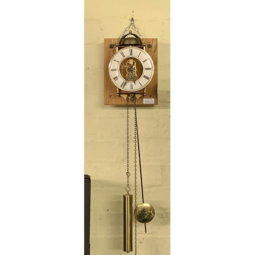 371 - A REPRODUCTION CHIMING LANTERN WALL CLOCK MOUNTED ON A BLOCK OF RED OAK G.W.O.