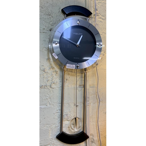 271 - A LONDON COMPANY QUARTZ HANGING WALL CLOCK WITH PENDULUM & Oak Aneroid Barometer marked Tars & W Lon... 