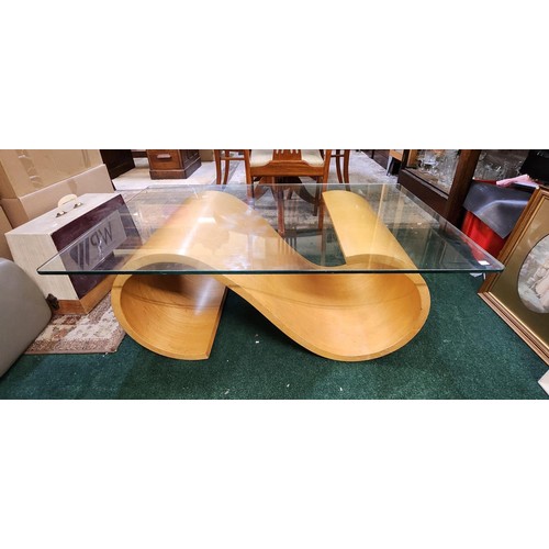 341 - A RECTANGULAR GLASS TOPPED COFFEE TABLE WITH BEECH SCROLL SUPPORTS