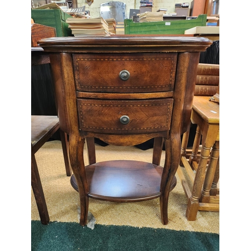 321 - A SMALL OVAL INLAID MAHOGANY NIGHTSTAND OR LAMP TABLE 2 DRAWERS AND UNDERSHLEF ON SPLAYED LEGS