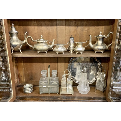 392 - 2 X SHELVES OF PLATED WARES INC. COFFEE AND TEA POTS, SHAKERS, CLARET JUG, TRAYS ETC.