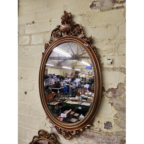 407 - AN OVAL GILDED FRENCH EMPIRE STYLE WALL MIRROR