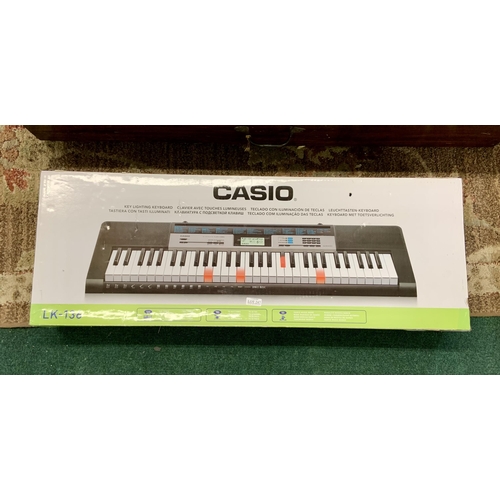 247 - BOXED CASIO LK -136 WITH BUILT IN TEACHING PROGRAMME, WITH POWER PACK, MUSIC STAND AND MANUAL