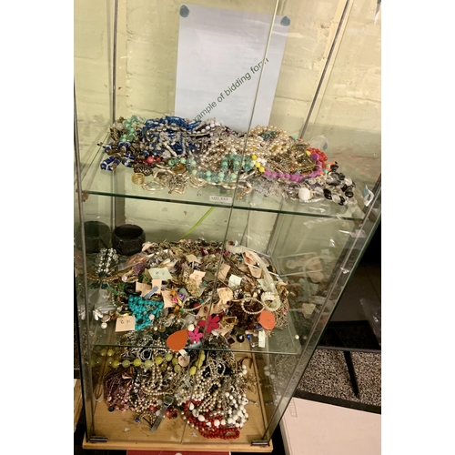 433 - VERY LARGE QUANTITY OF COSTUME JEWELLERY ACROSS THREE SHELVES INC NECKLACES BRACELETS EARRINGS BROOC... 