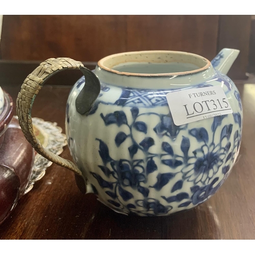 315 - A Chinese Blue & White Lobed Teapot in the Kangxi style with a rattan covered bronze (?) handle - No... 