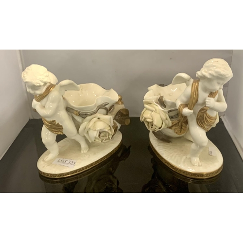 355 - A PAIR OF MOORE BROTHERS VICTORIAN PROCELAIN CHERUB FIGURES WITH BASKETS AND FLORAL DECORATION IN GI... 