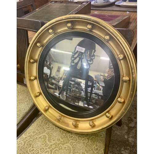 401 - A VINTAGE GILT FRAMED CIRCULAR CONVEX MIRROR WITH BALL DECORATION