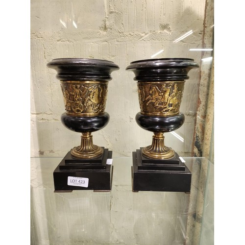 423 - A PAIR OF 19TH C. BLACK SLATE & BRASS CLASSICAL SHAPED URNS -CLASSICAL FIGURES EMBOSSED